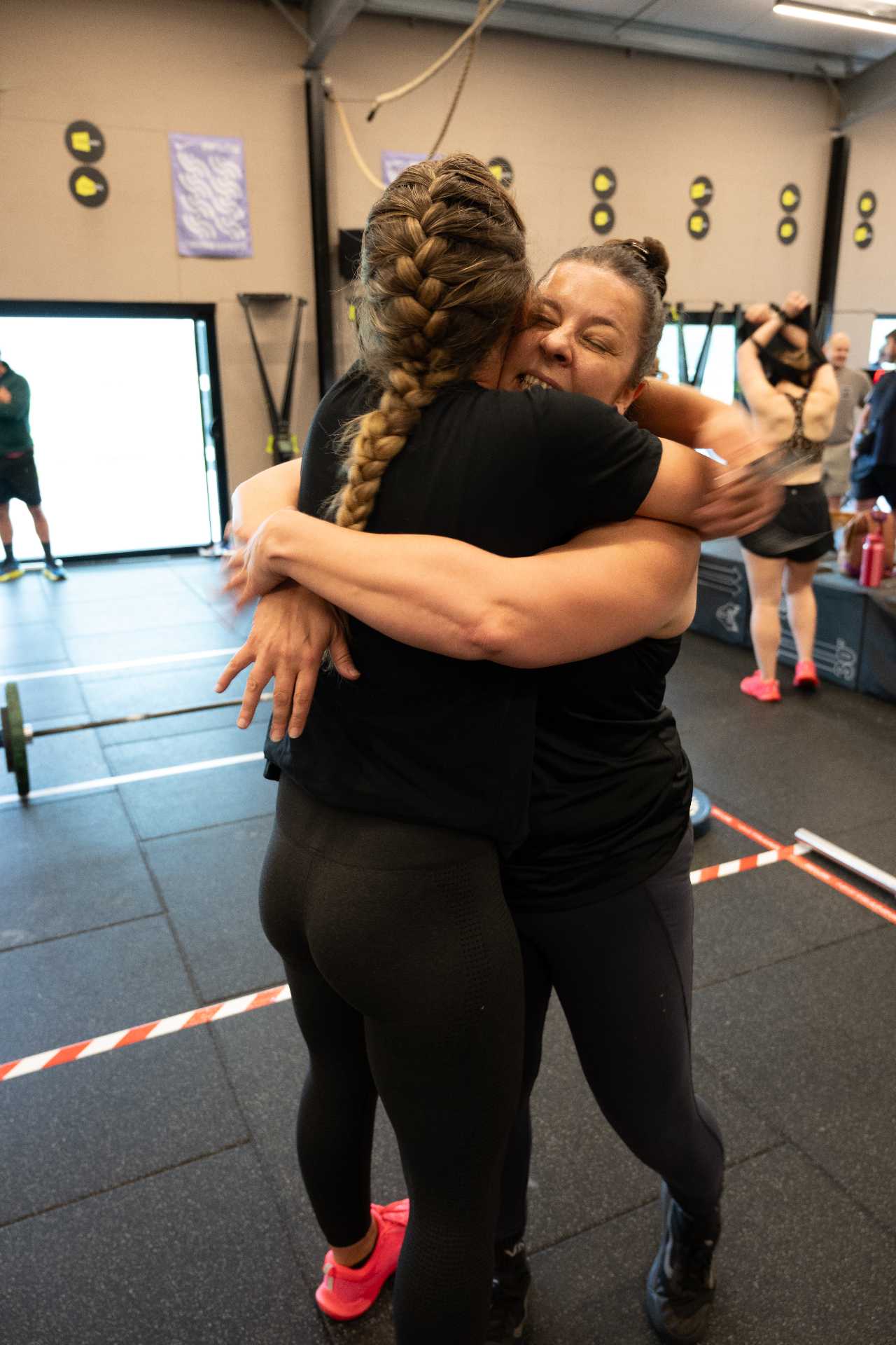 Two Beyond Walls members embracing after a workout