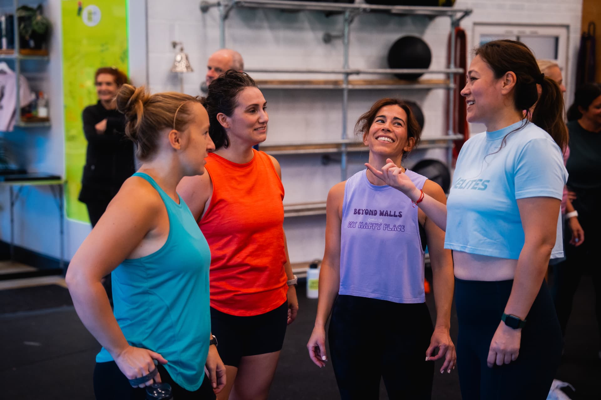Beyond Walls members laughing together inside the gym