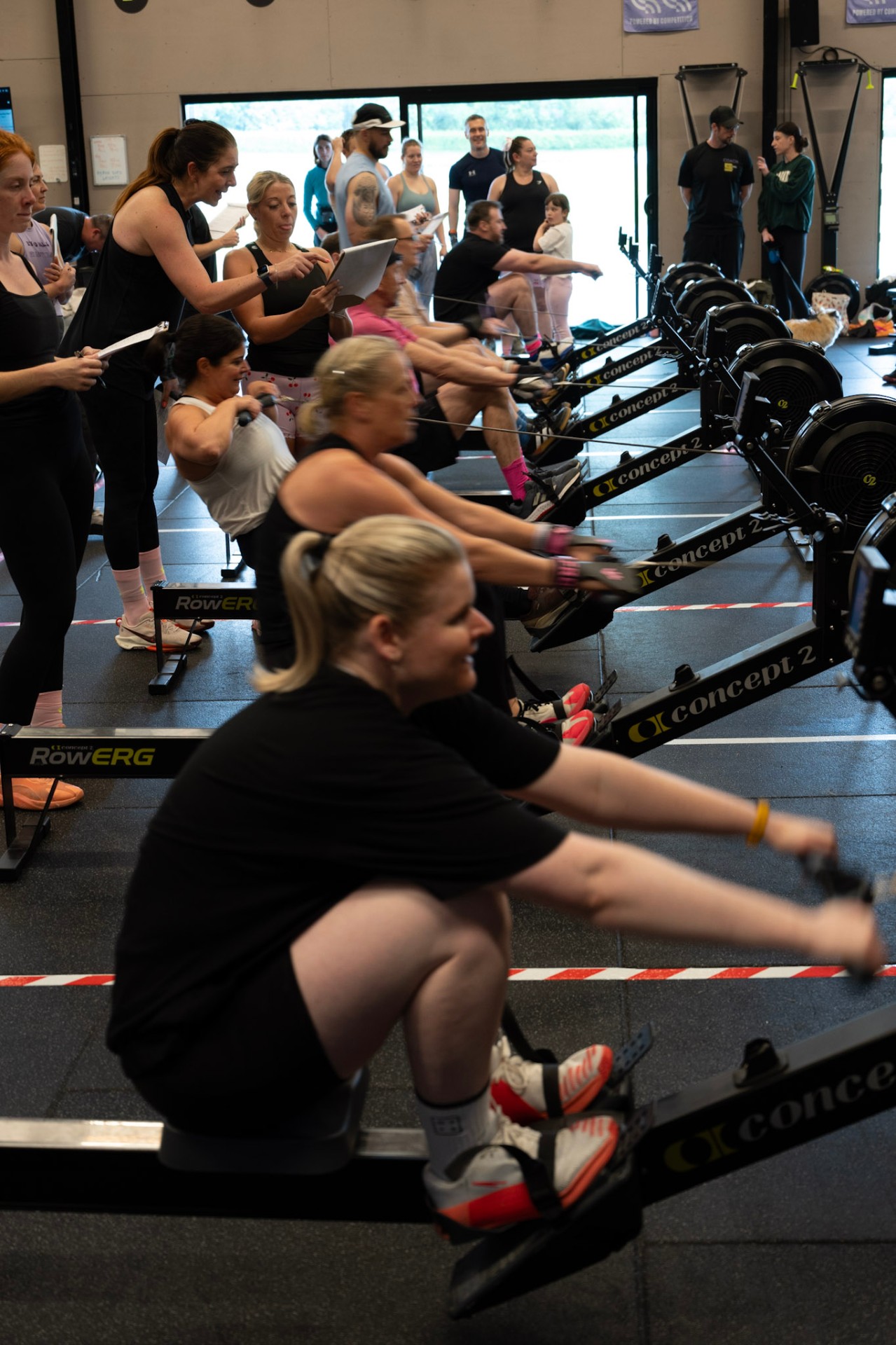 Row of members on Concept2 rowers during a class